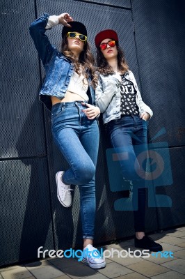 Young Beautiful Girls With Denim Suit In A Urban Background Stock Photo