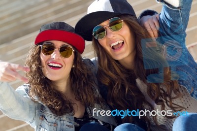 Young Beautiful Girls With Denim Suit In A Urban Background Stock Photo