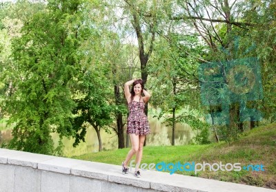 Young Beautiful Smiling Girl Posing While Standing In The Park Stock Photo