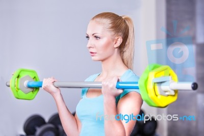 Young Beautiful Strong Blond Woman With Barbell And Weight Plate… Stock Photo