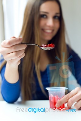 Young Beautiful Woman Eating Yogurt At Home Stock Photo