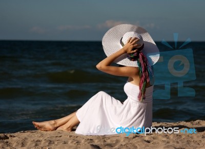 Young Beautiful Woman In A White Dress On The Beach Stock Photo