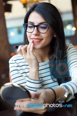 Young Beautiful Woman Making Up Her Face Stock Photo