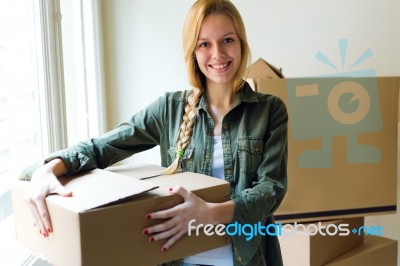 Young Beautiful Woman Moving In A New Home Stock Photo