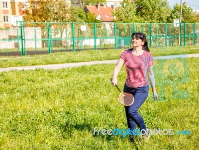 Young Beautiful Woman Playing Badminton Stock Photo