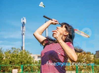 Young Beautiful Woman Playing Badminton Stock Photo