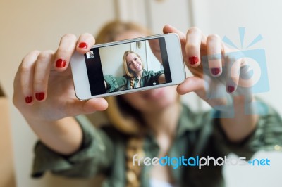 Young Beautiful Woman Taking A Selfie With Smartphone In Her New… Stock Photo