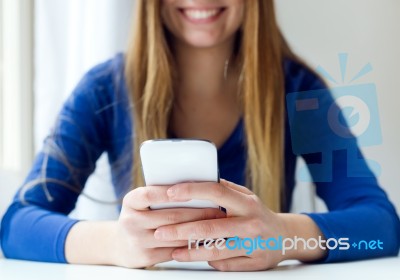 Young Beautiful Woman Using Her Mobile Phone At Home Stock Photo