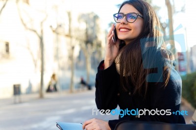 Young Beautiful Woman Using Her Mobile Phone In The Street Stock Photo