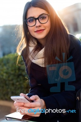 Young Beautiful Woman Using Her Mobile Phone In The Street Stock Photo