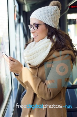 Young Beautiful Woman Using Her Mobile Phone On A  Bus Stock Photo