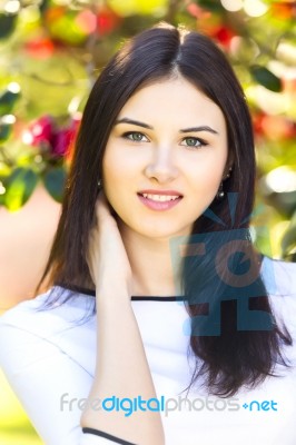 Young Beautiful Woman With Long Straight Dark Hair Posing In Gar… Stock Photo