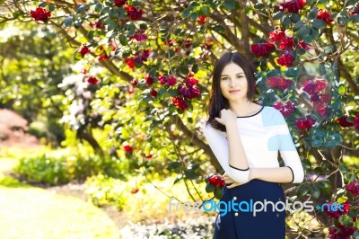 Young Beautiful Woman With Long Straight Dark Hair Posing In Spr… Stock Photo