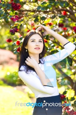 Young Beautiful Woman With Long Straight Dark Hair Posing In Spr… Stock Photo