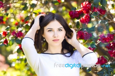 Young Beautiful Woman With Long Straight Dark Hair Posing In Spr… Stock Photo