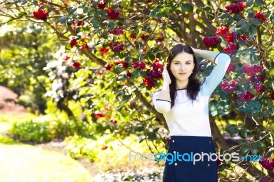 Young Beautiful Woman With Long Straight Dark Hair Posing In Spr… Stock Photo