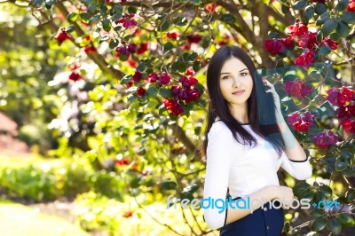 Young Beautiful Woman With Long Straight Dark Hair Posing In Spr… Stock Photo