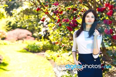 Young Beautiful Woman With Long Straight Dark Hair Posing In Spr… Stock Photo