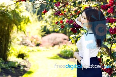 Young Beautiful Woman With Long Straight Dark Hair Posing In Spr… Stock Photo