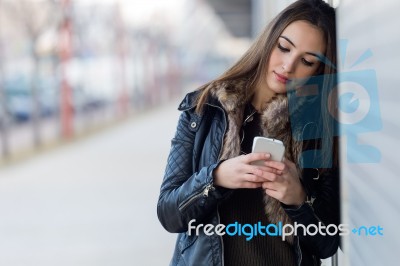 Young Beautiful Woman With Mobile Phone In The Street Stock Photo