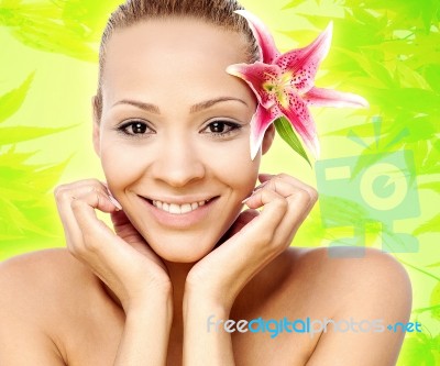 Young Beautiful Woman With Pink Flower Stock Photo