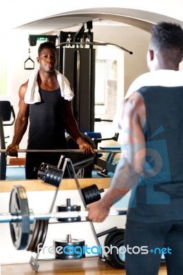 Young Bodybuilder Lifting The Barbell Stock Photo