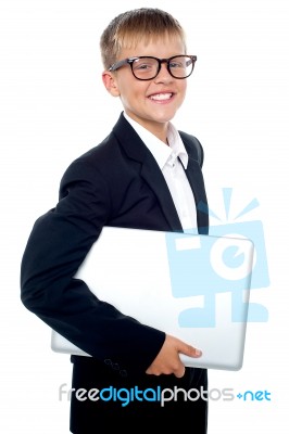 Young Boy Carrying Laptop Stock Photo