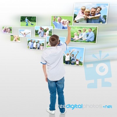 Young Boy Choosing His Outdoor Photo To Share Stock Photo