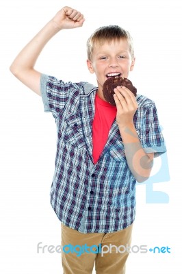 Young Boy Eating Chocolate Cookie Stock Photo