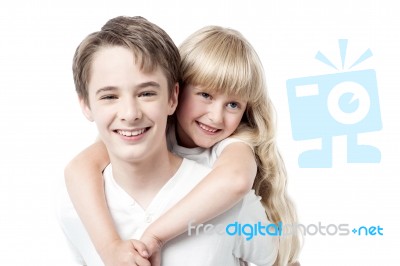 Young Boy Giving Little Girl Piggyback Ride Stock Photo