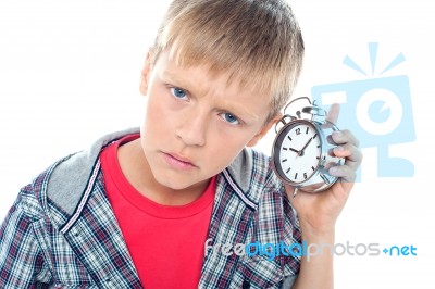 Young Boy Holding Alarm Clock Stock Photo