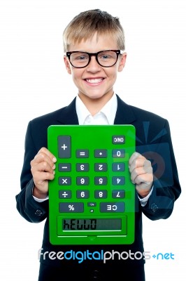 Young boy Holding Calculator Upside Stock Photo