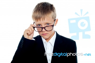 Young boy Removing Eyeglass Stock Photo