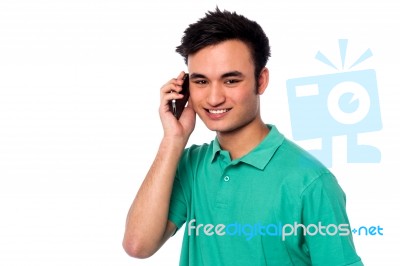 Young Boy Speaking Over Cellphone Stock Photo