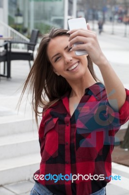 Young Brunette With A Smart Phone Stock Photo