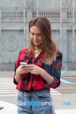 Young Brunette With A Smart Phone Stock Photo