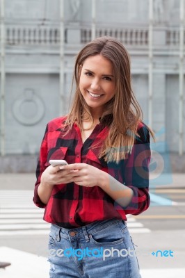 Young Brunette With A Smart Phone Stock Photo