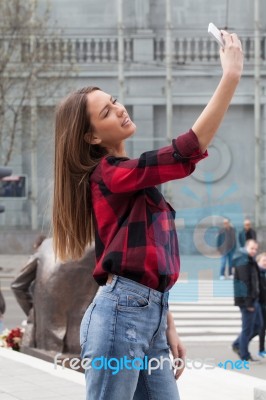 Young Brunette With A Smart Phone Stock Photo