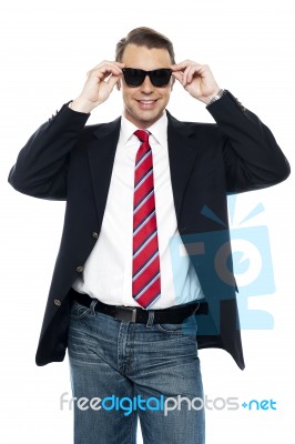 Young Business Achiever Holding Shades In Style Stock Photo