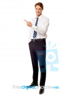 Young Business Executive Pointing Away Stock Photo