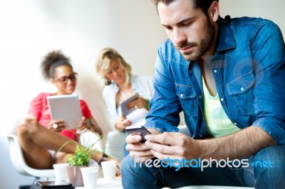 Young Business Man Using His Mobile Phone, In The Background Bus… Stock Photo