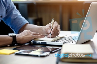 Young Business Man Working In Bright Office, Using Laptop, Writi… Stock Photo