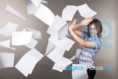 Young Business Woman With Flying Documents Stock Photo