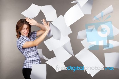 Young Business Woman With Flying Documents Stock Photo