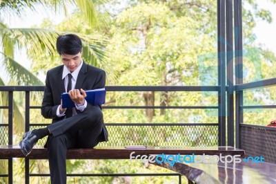 Young Businessman Looking At Report Paper Stock Photo