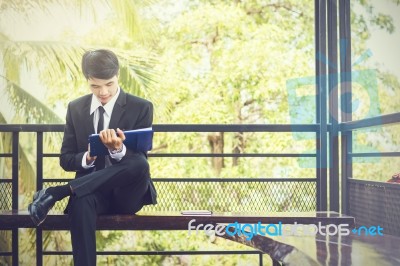 Young Businessman Looking At Report Paper Stock Photo