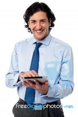 Young Businessman Operating Tablet Device Stock Photo