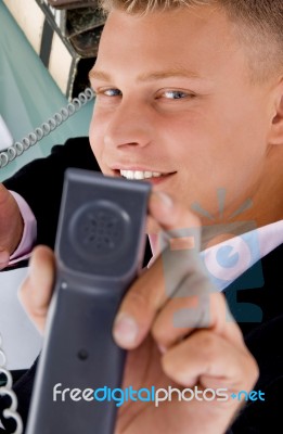 Young Businessman Showing Receiver Stock Photo