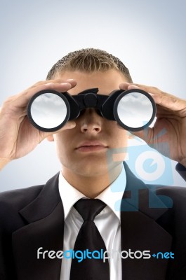 Young Businessman Using Binoculars Stock Photo