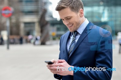 Young Businessman Using His Mobile Phone Stock Photo